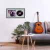 Minimalistic interior design concept. Acoustic guitar on grey textile sofa in spacious room of loft style apartment with wood textured laminated flooring. Background, copy space, close up.
