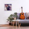 Minimalistic interior design concept. Acoustic guitar on grey textile sofa in spacious room of loft style apartment with wood textured laminated flooring. Background, copy space, close up.