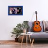 Minimalistic interior design concept. Acoustic guitar on grey textile sofa in spacious room of loft style apartment with wood textured laminated flooring. Background, copy space, close up.