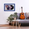 Minimalistic interior design concept. Acoustic guitar on grey textile sofa in spacious room of loft style apartment with wood textured laminated flooring. Background, copy space, close up.