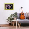 Minimalistic interior design concept. Acoustic guitar on grey textile sofa in spacious room of loft style apartment with wood textured laminated flooring. Background, copy space, close up.