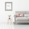 Interior wall mock up with gray sofa, pink pillows and plant in vase in living room with empty white wall. 3D rendering.
